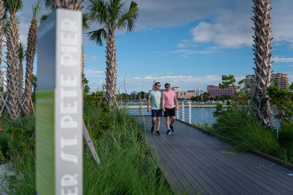 couple walking on pathway overlooking bay