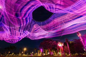 colorful aerial sculpture lit up at night