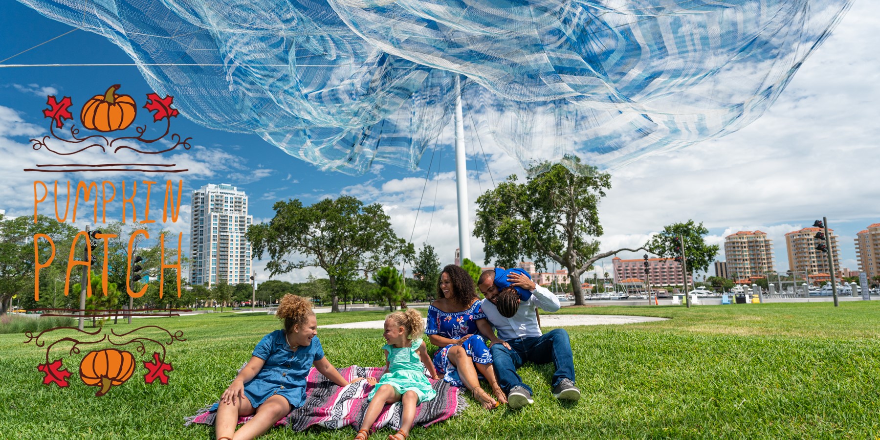 family sitting under net sculpture